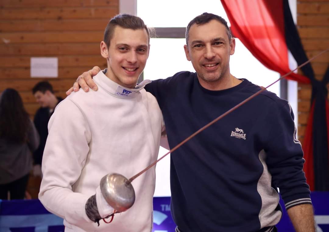 Alexandros with his father at a fencing event